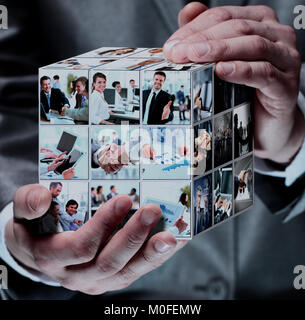 cube with business collage in the businessman hands Stock Photo