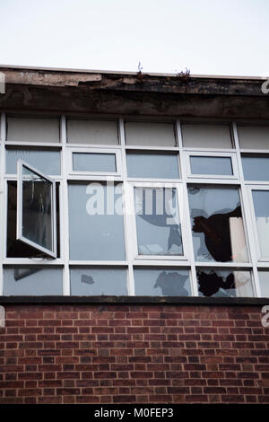 view of an old demolished building and smashed windows with broken ...