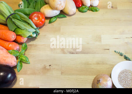 Vegetable mix on wooden table. Empty space for text or design. Health food concept for vegan, vegetarian, weight-loss diet. Stock Photo