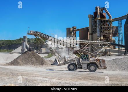 Caterpillar wheel loader driving to the brick factory at the Mount Saint Peter ENCI (First Dutch Cement Industry) quarry, Maastricht, The Netherlands. Stock Photo