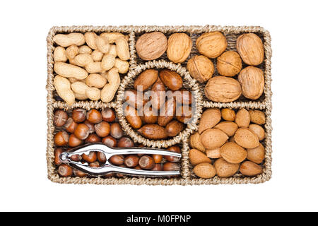 Basket reach in various kinds of nuts in shells, pecans, almonds, hazelnuts, peanuts and walnuts on white background Stock Photo