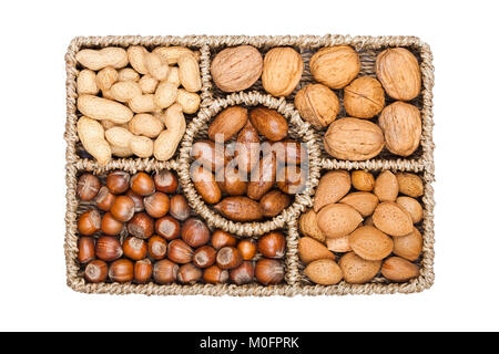 Basket reach in various kinds of nuts in shells, pecans, almonds, hazelnuts, peanuts and walnuts on white background Stock Photo