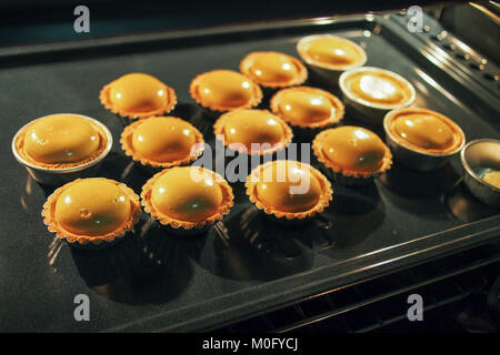 close up view of homemade egg tart baking in the oven Stock Photo