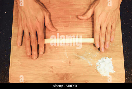 man kneading raw donut dough Stock Photo