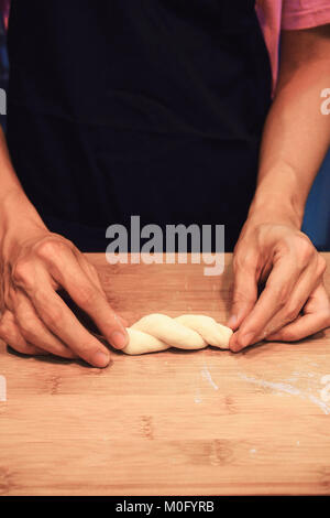 man kneading raw donut dough Stock Photo