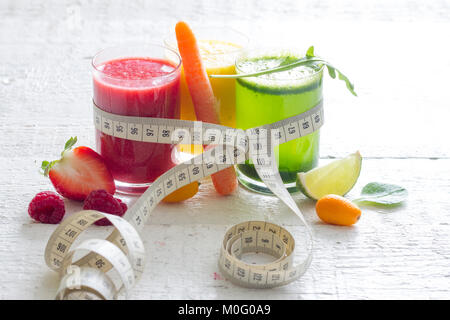 Fresh juices measuring tape fruits and vegetables lose weight diet concept Stock Photo