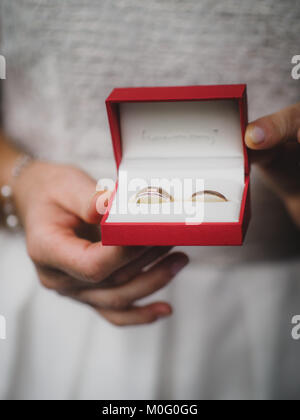 The bride holds her wedding ring in the camera Stock Photo