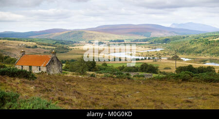 The River Oykel flows into the Kyle of Sutherland in Strath Kyle under the crofting farms and mountains of the Highlands of Scotland. Stock Photo