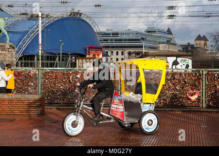 Europe, Germany, Cologne, rickshaw for sightseeing, in the background the theatre Musical Dome  Europa, Deutschland, Koeln, Fahrrad-Rikscha fuer Stadt Stock Photo