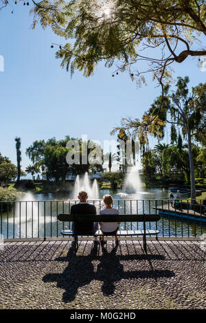 Couple relaxing in the sun at Santa Catarina Park, Funchal, Madeira Stock Photo