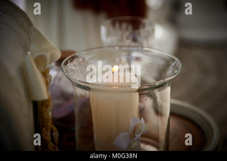 Closeup image of wedding candle burning on table, symbol of family Stock Photo