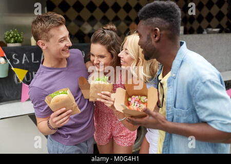 happy friends with wok and burger at food truck Stock Photo