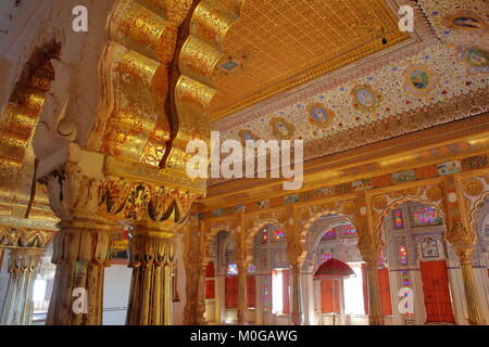 JODHPUR, RAJASTHAN, INDIA - DECEMBER 17, 2017: Golden Royal Palace room with architectural details, carvings and columns at Mehrangarh Fort Stock Photo