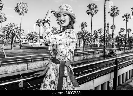 Summertime at colorful Barcelona. happy elegant woman in long dress and straw hat in Barcelona, Spain having fun time Stock Photo