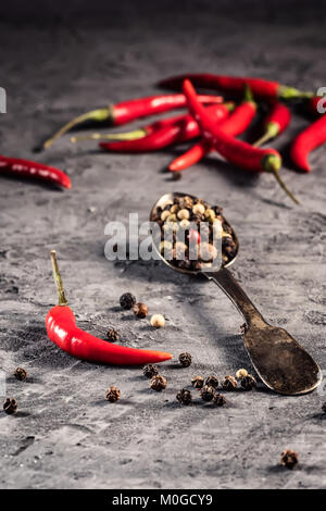 Red hot chilli pepper paprika in and peppers seed ball on stone table Ingredient for Mexican cooking, Trendy toned image in minimal rustic style Stock Photo