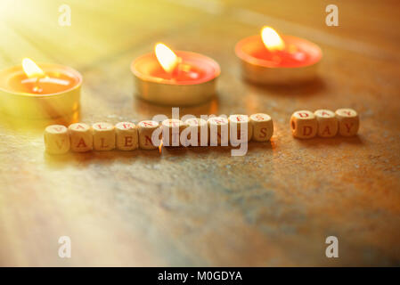 The Word Happy Valentine’s Day wooden cubes on a wooden background. Stock Photo