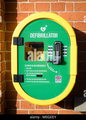 Public Defibrillator on a wall. The user dials 999 to get the open code before using the Defibtech Lifeline auto defibrillator. Stock Photo