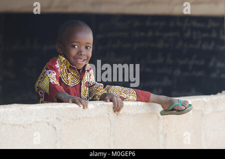 Background of African Boy Jumping Over Wall with Copy Space Stock Photo