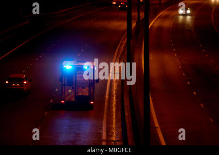 ambulance speeding along motorway with blue lights flashing in northern ireland uk Stock Photo