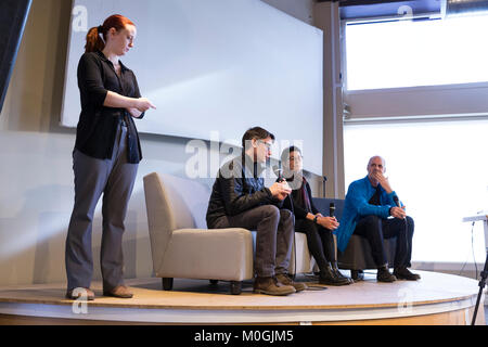 Seattle, Washington, USA. 21st Jan, 2018. Film producers Luke Sieczek, Caryn Cline and Rod Huntress (seated l-to-r) take questions at the Impact Hub after the screening of their documentary films about the 2017 Woman’s March on Seattle. Credit: Paul Christian Gordon/Alamy Live News Stock Photo