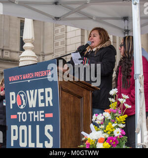 Lansing, Michigan USA - 21 January 2018 - On the first anniversary of the Women's March in Washington which protested the inauguration of President Donald Trump, women marched in cities across the country encouraging women to vote for alternatives in the 2018 mid-term elections. Cindy Garcia, whose husband Jorge Garcia had been deported to Mexico a few days earlier after living in the U.S. for nearly 30 years, spoke to the Lansing rally. The couple's children were with her: Solieil, 15 (right) and Jorge Jr., 12 (partially visible). Cindy Garcia is a member of United Auto Workers Local 600. Cre Stock Photo