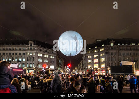 London, UK. 20th Jan, 2018. Members of the public enjoy French artist Miguel Chevalier’s ‘Shaida Origin of the World Bubble 2018’ giant globe installation suspended above Oxford Circus as part of Lumiere London. Credit: Guy Corbishley/Alamy Live News Stock Photo