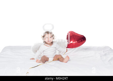 little angel with wings and nimbus holding red heart balloon, isolated on white Stock Photo