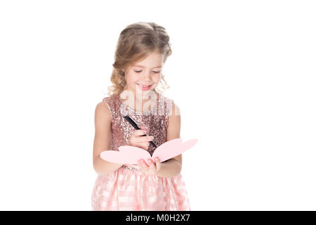 adorable child writing valentines greeting card, isolated on white Stock Photo