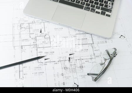black pencil and computer laptop on architectural drawing paper for construction Stock Photo