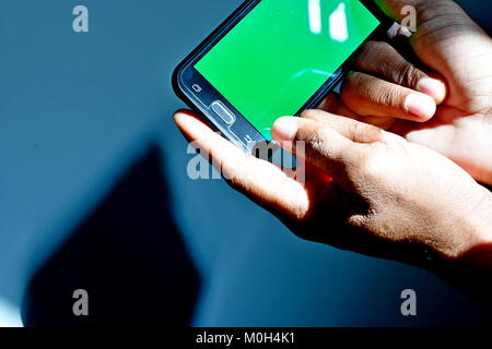 Green screen ready android and man viewing against striped window of ...