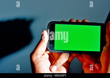 Green screen ready android and man viewing against striped window of ...