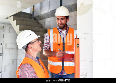 teamwork on the construction site - site manager and architect on site during the construction of a house Stock Photo