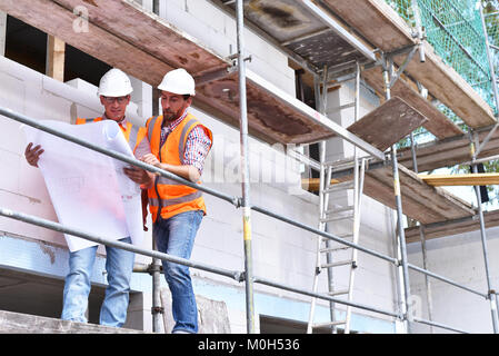 teamwork on the construction site - site manager and architect on site during the construction of a house Stock Photo