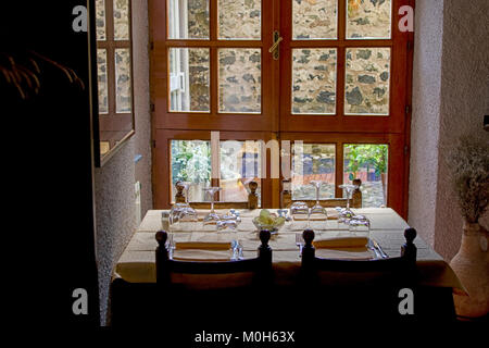 beautiful set dinnertable in italian restaurant in front of wooden window Stock Photo