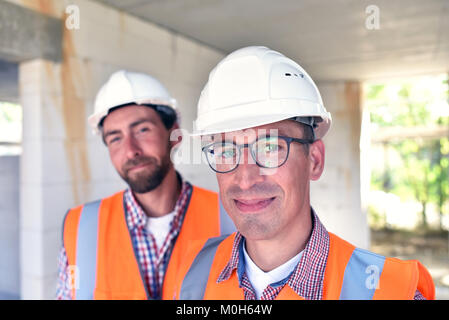 teamwork on the construction site - site manager and architect on site during the construction of a house Stock Photo