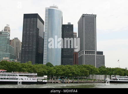 View of Lower Southern Manhattan with Battery Park and the high-rise office buildings including the 1 New York Plaza Building together with Lady Liber Stock Photo