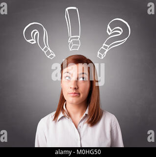 Beautiful young lady thinking with question marks overhead Stock Photo