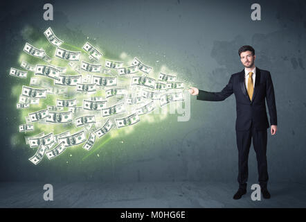 Business person throwing a lot of dollar bills concept on background Stock Photo