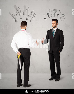 Ruthless businessman handshake with drawn exclamation and question marks around them head Stock Photo