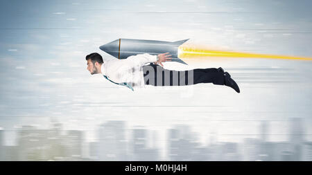 Superhero business man flying with jet pack rocket above the city concept Stock Photo