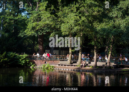 People relaxing at the Cafe Am Neuen See in the Tiergarten, Berlin, Germany.
