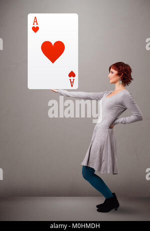 Beautiful young woman holding red heart ace Stock Photo