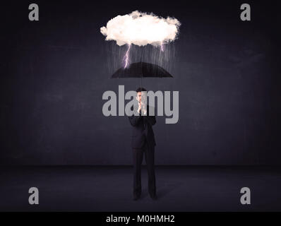 Businessman standing with umbrella and little storm cloud concept on background Stock Photo