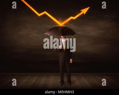 Businessman standing with umbrella keeping orange arrow concept on background Stock Photo