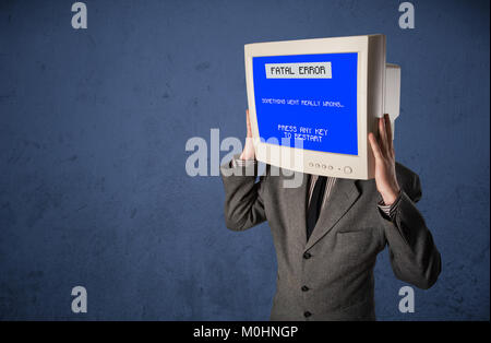 Person with a monitor head and fatal error blue screen on the display Stock Photo