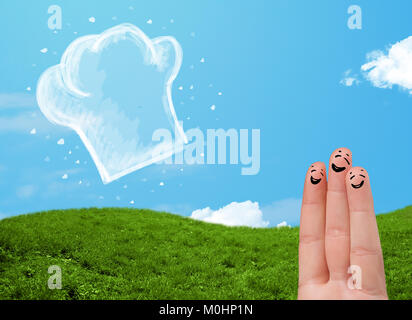 Happy smiley face fingers cheerfully looking at  illustration of cook hat Stock Photo