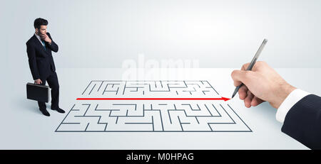 Business man looking at hand drawing solution for maze solution concept Stock Photo