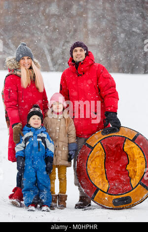 Photo of parents with daughter and son on winter walk Stock Photo