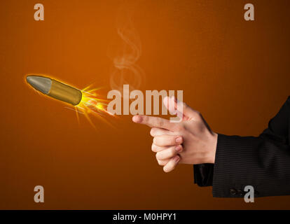 Gun shaped male hand with bullet coming out of it Stock Photo