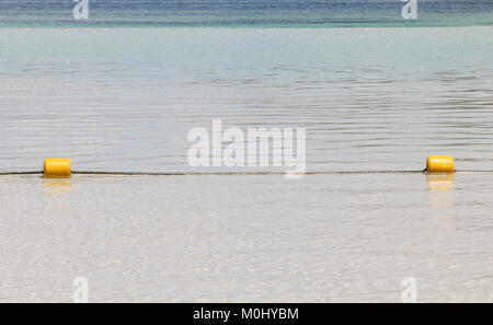 Yellow buoy rope in shallow water on the beach, Ile Aux Cerfs, privately owned island near the east coast of The Republic of Mauritius in the Flacq Di Stock Photo